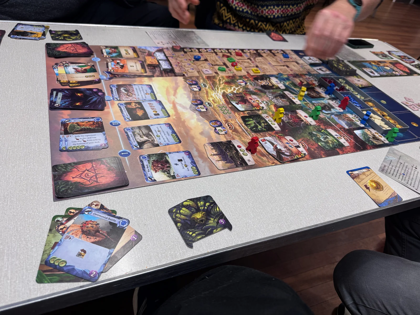 A colourful board game set up across a club table